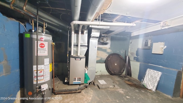 utility room with heating unit and gas water heater