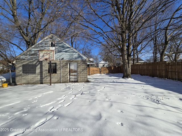 yard layered in snow with basketball court