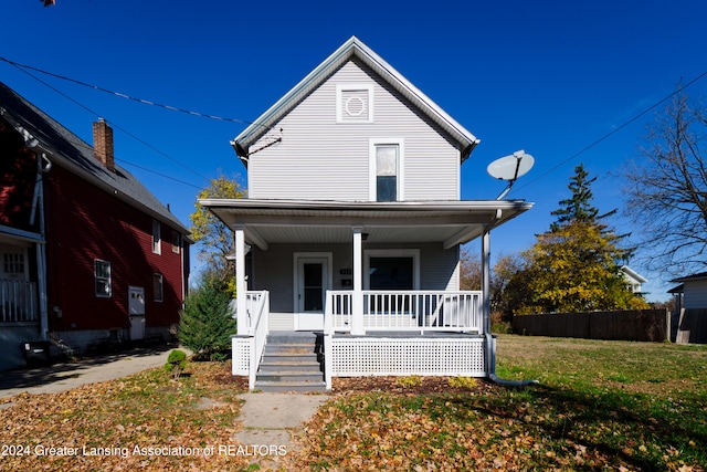 view of front property with a front yard and covered porch