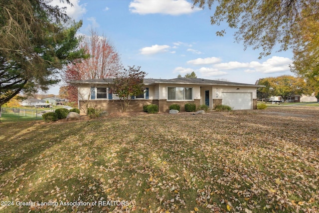 ranch-style house with a front yard and a garage