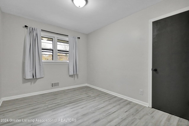 unfurnished room with light wood-type flooring