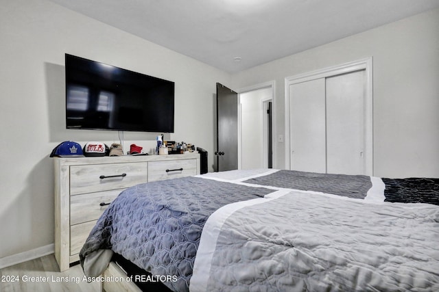 bedroom featuring hardwood / wood-style floors and a closet