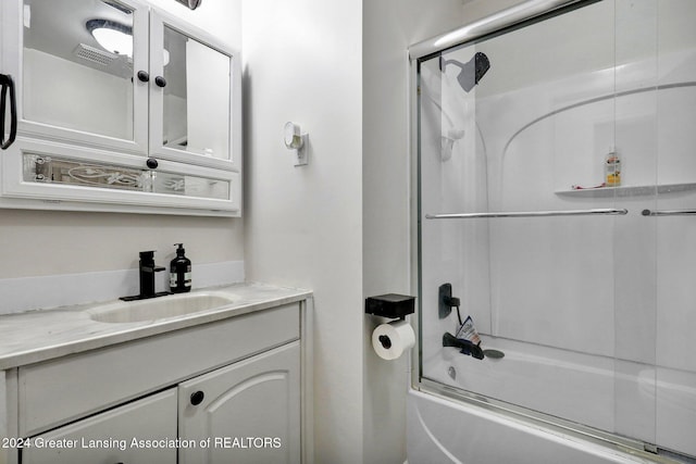 bathroom with enclosed tub / shower combo and vanity