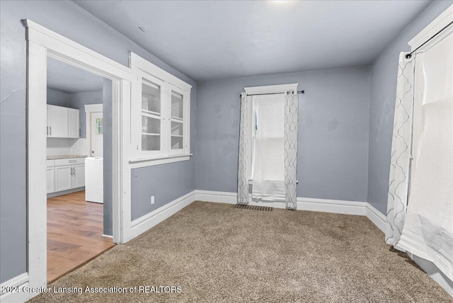 empty room featuring a healthy amount of sunlight and light hardwood / wood-style flooring