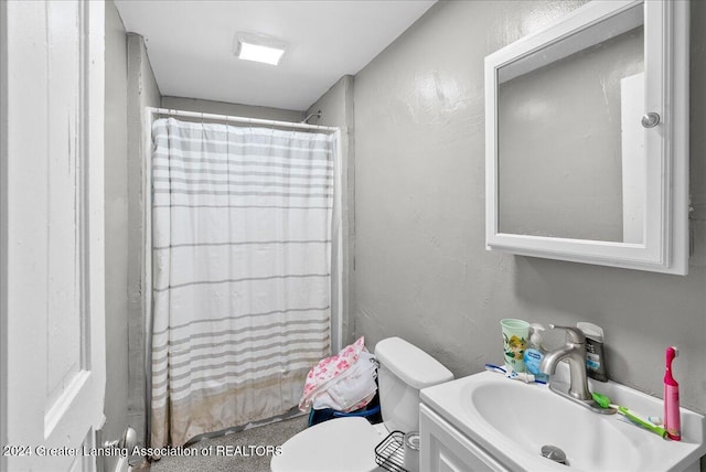 bathroom featuring vanity, toilet, and a shower with curtain