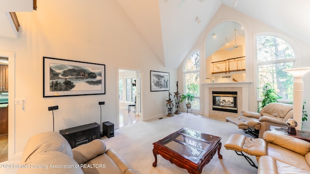 living room with high vaulted ceiling, light colored carpet, and a fireplace