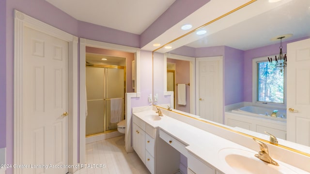 full bathroom with toilet, vanity, and separate shower and tub