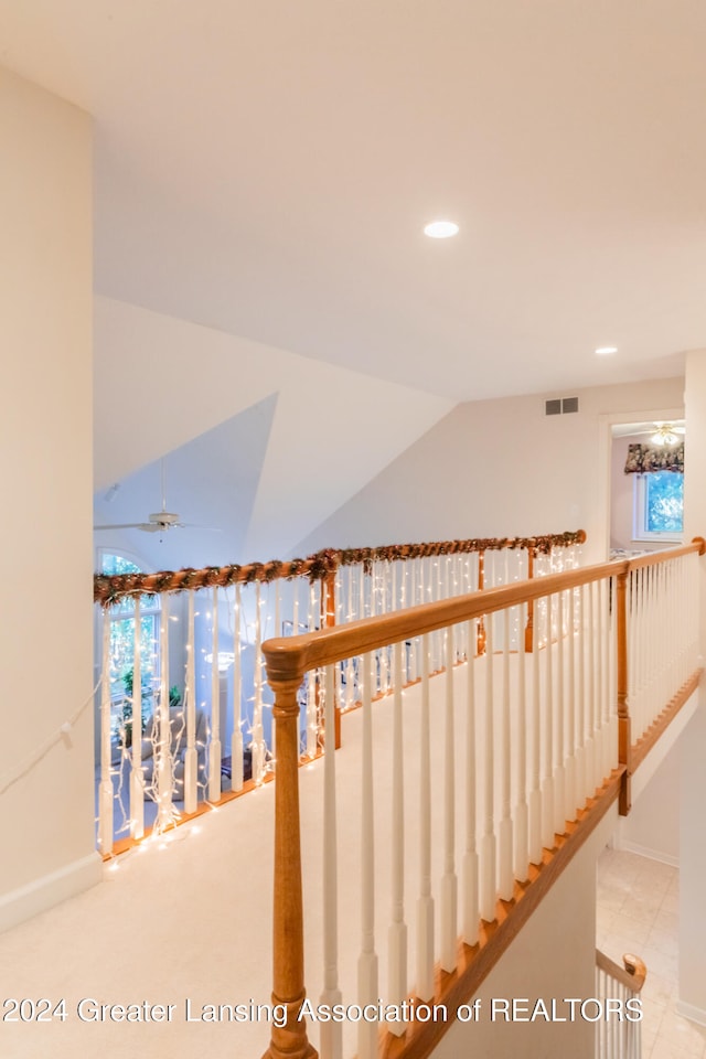 staircase featuring vaulted ceiling