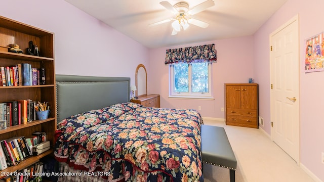 bedroom with ceiling fan and light carpet