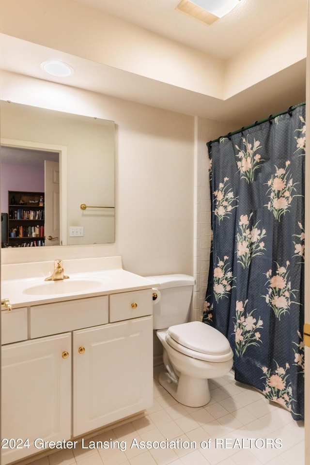 4710 Wellington Dr, Okemos, MI 48864 - bathroom featuring tile patterned flooring, vanity, toilet, and a shower with shower curtain