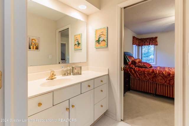4710 Wellington Dr, Okemos, MI 48864 - bathroom featuring connected bathroom, vanity, baseboards, and tile patterned floors