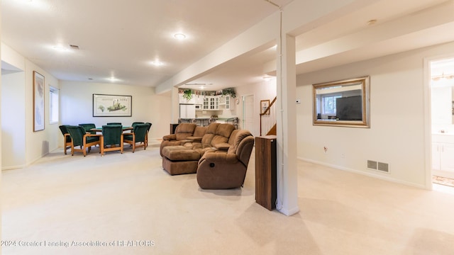 4710 Wellington Dr, Okemos, MI 48864 - living area featuring carpet floors, stairs, baseboards, and bar area