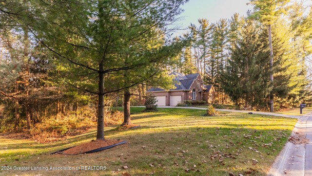 4710 Wellington Dr, Okemos, MI 48864 - view of home's exterior featuring a lawn and driveway