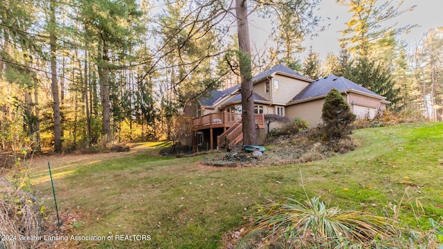 4710 Wellington Dr, Okemos, MI 48864 - view of grassy yard with a deck and an attached garage