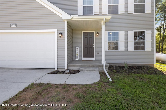 view of exterior entry with a garage