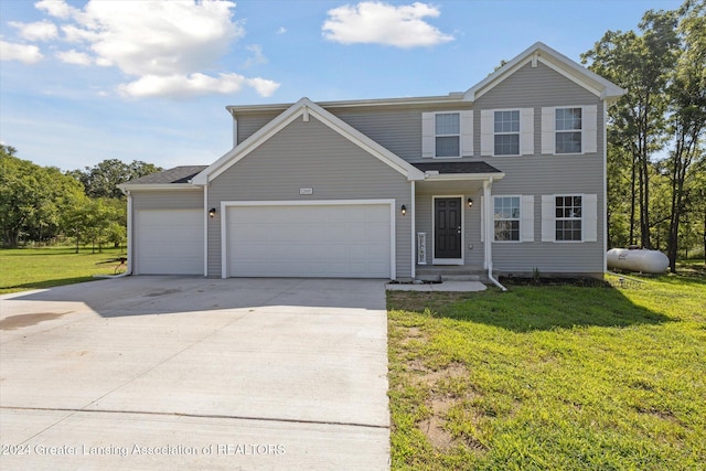 front of property with a front lawn and a garage