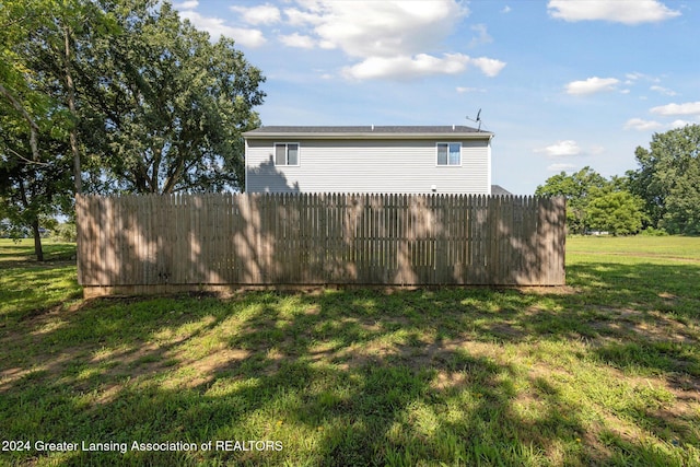 view of property exterior featuring a lawn