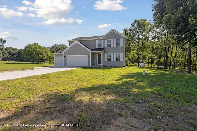 view of property featuring a front lawn and a garage