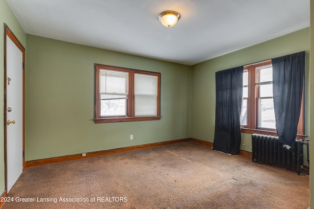 carpeted empty room with radiator