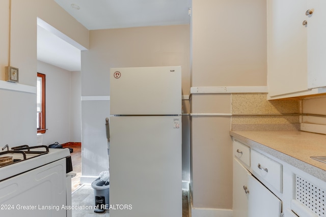 602 N Pennsylvania Ave, Lansing, MI 48912 - kitchen with white appliances, white cabinetry, and light countertops