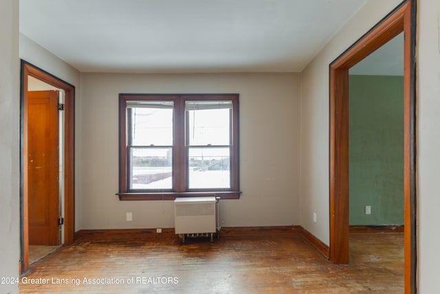 602 N Pennsylvania Ave, Lansing, MI 48912 - unfurnished room with radiator heating unit and hardwood / wood-style flooring