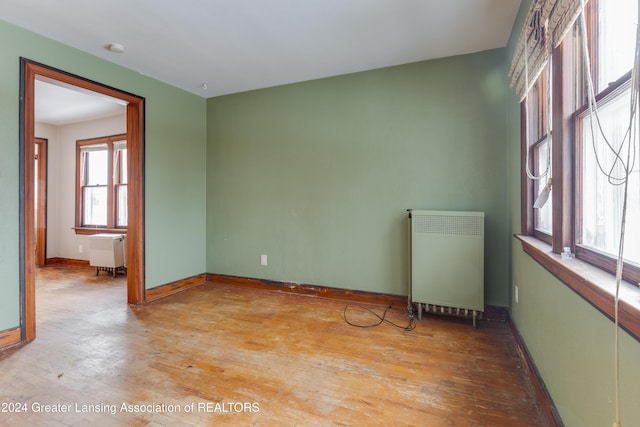 602 N Pennsylvania Ave, Lansing, MI 48912 - spare room featuring radiator, hardwood / wood-style floors, and a smoke detector