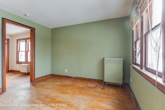 602 N Pennsylvania Ave, Lansing, MI 48912 - unfurnished room featuring radiator heating unit and wood finished floors