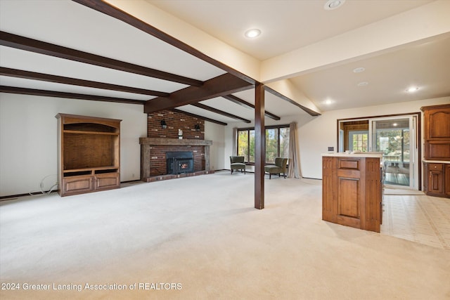 unfurnished living room with light colored carpet, vaulted ceiling with beams, and a fireplace