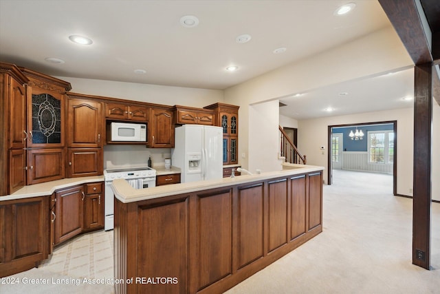 kitchen featuring light colored carpet, lofted ceiling, white appliances, and a kitchen island