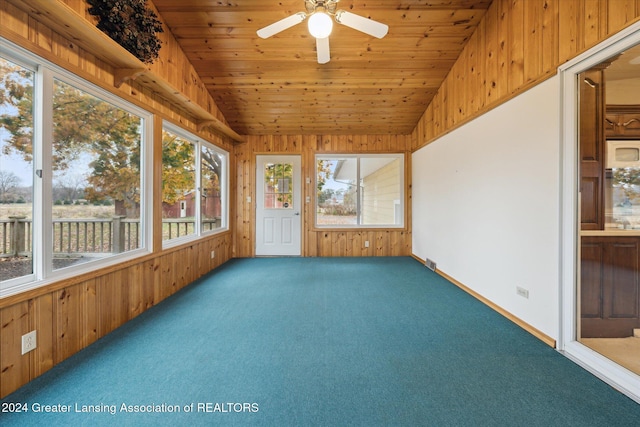 unfurnished sunroom with ceiling fan, wood ceiling, and lofted ceiling