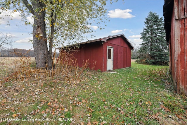 view of outbuilding featuring a yard