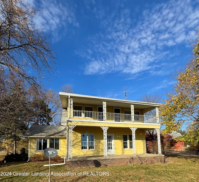 view of front of property with a balcony and covered porch