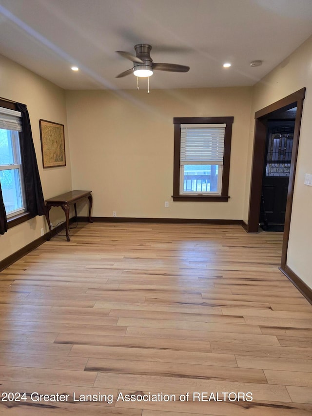 empty room featuring light wood-type flooring and ceiling fan