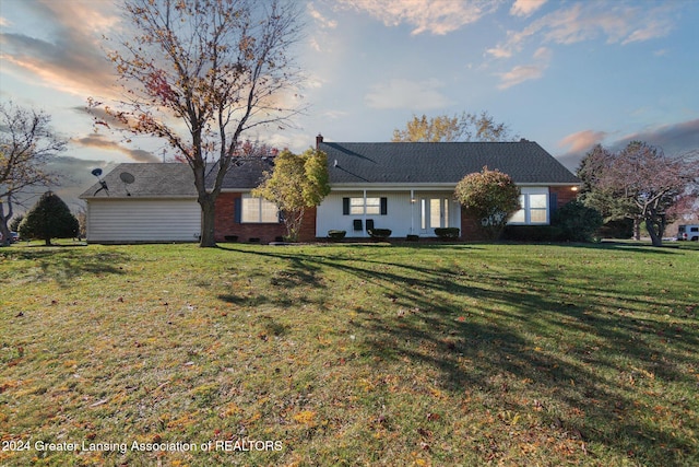 ranch-style home featuring a yard