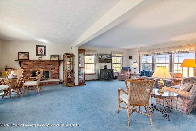 carpeted living room with a brick fireplace and a textured ceiling