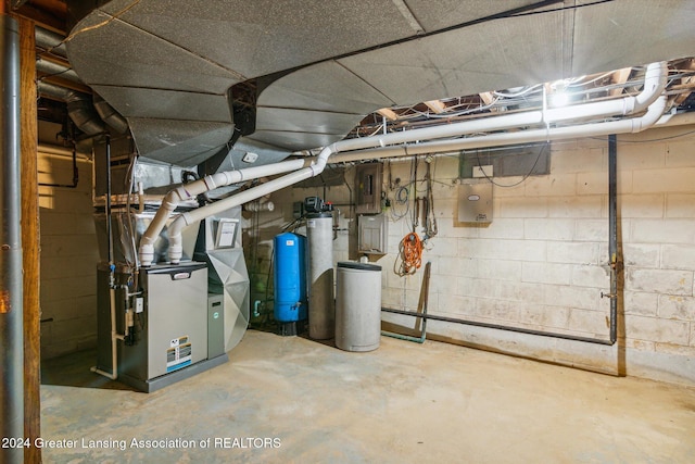 basement featuring electric panel and heating unit