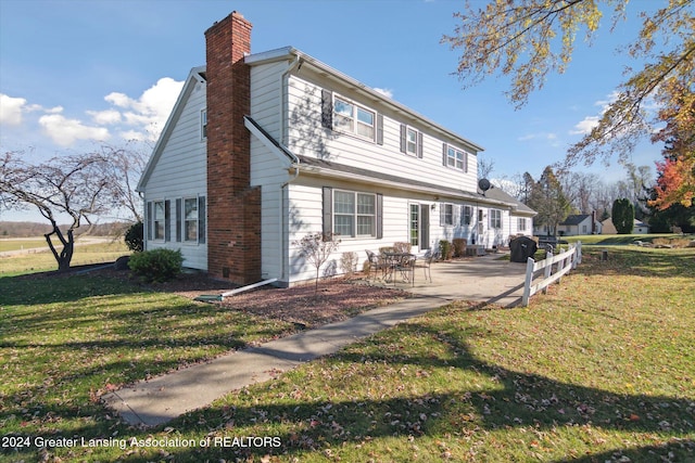 view of front of house with a front lawn and a patio