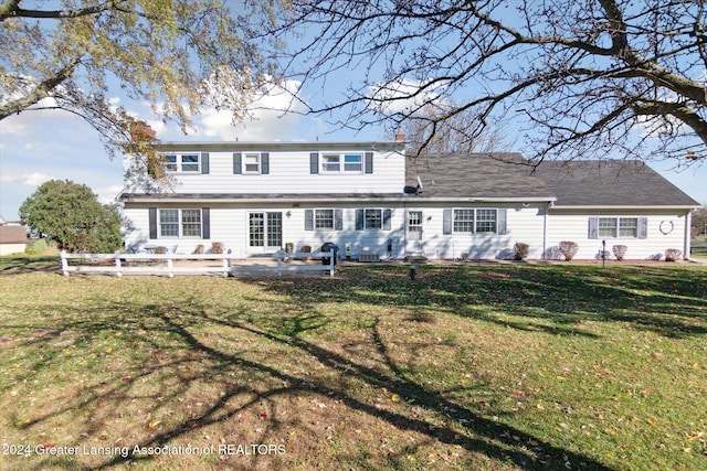 rear view of property with a patio and a yard