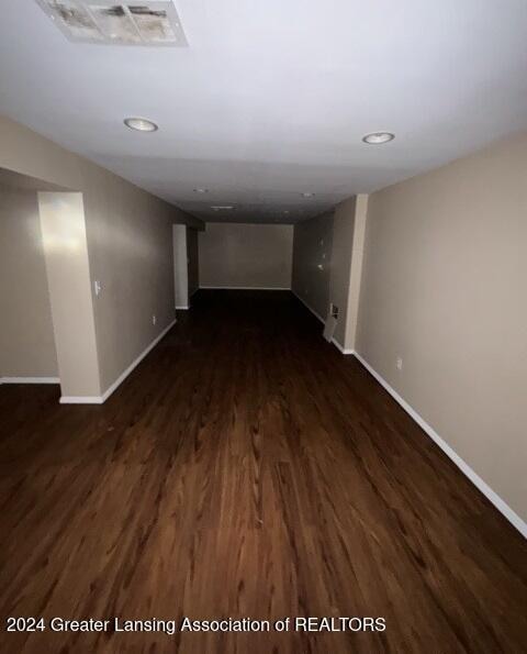 basement with dark hardwood / wood-style flooring