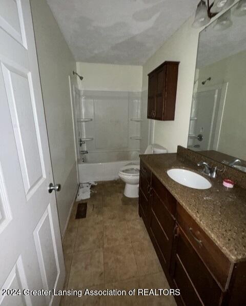 full bathroom featuring toilet, tile patterned flooring, a textured ceiling, vanity, and shower / tub combination