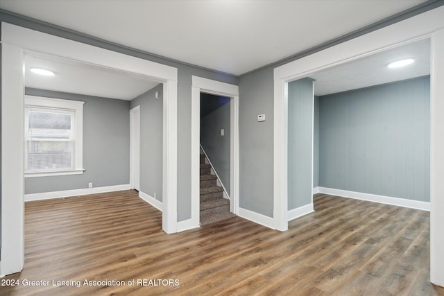 basement with wood walls and dark hardwood / wood-style floors