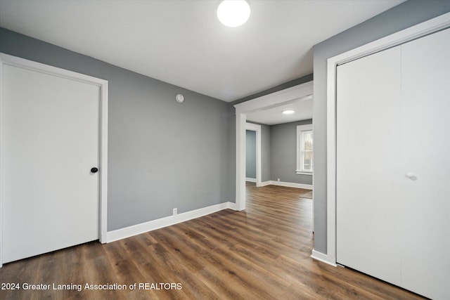 empty room with dark hardwood / wood-style floors