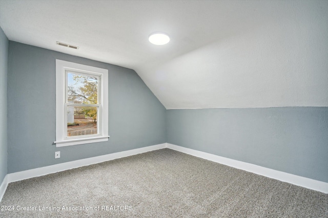 bonus room featuring carpet and lofted ceiling