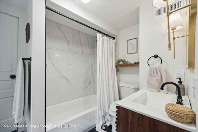 full bathroom with shower / bath combo, vanity, a textured ceiling, and toilet