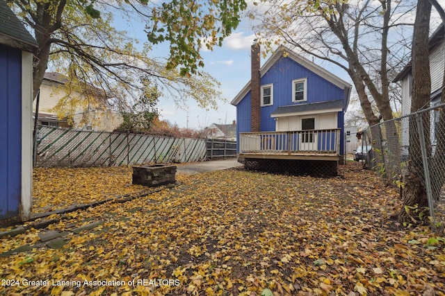 back of property featuring a wooden deck