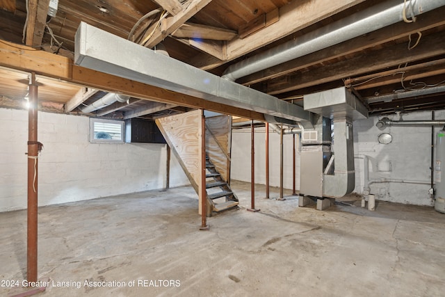 basement featuring heating unit and gas water heater