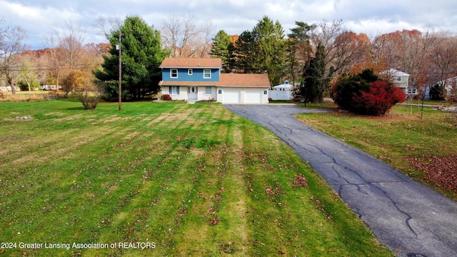 view of front of property with a front yard and a garage