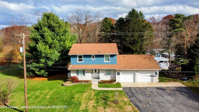 view of property with a garage and a front yard