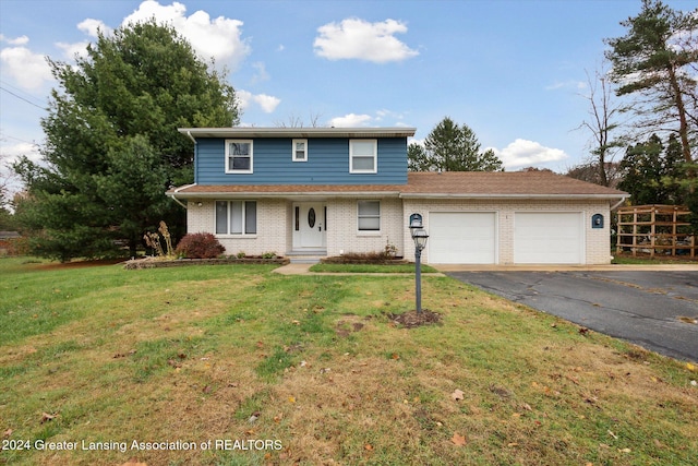 front of property with a front yard and a garage