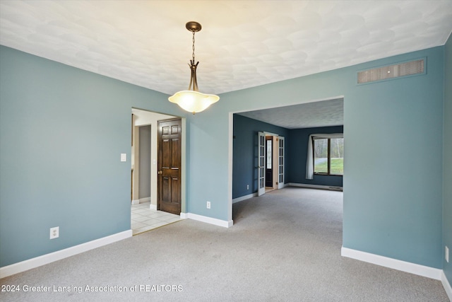 carpeted spare room featuring a baseboard heating unit